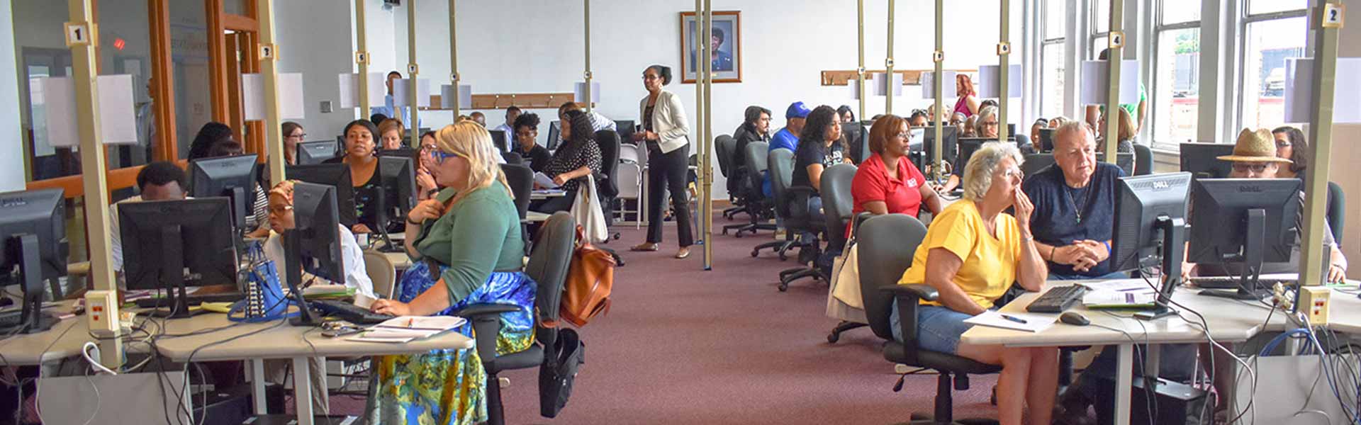 Group of adults learning on computers