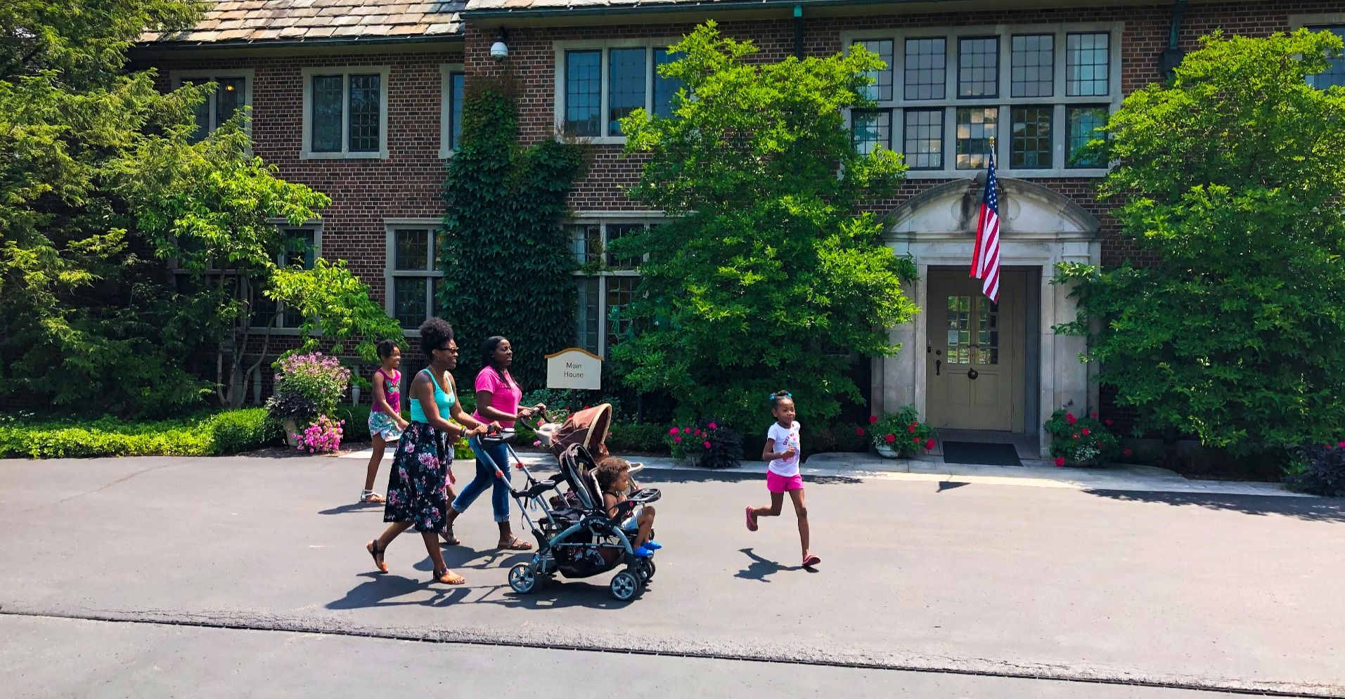 Family walking past the historic home at Applewood