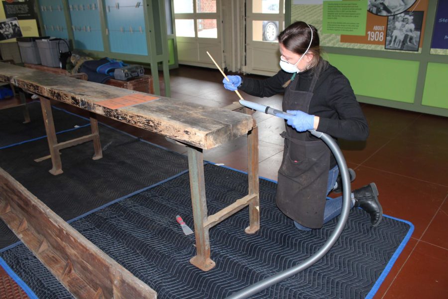 Wood conservator, Magali Maus, in 2019 working on a bench from the Weston-Mott factory.