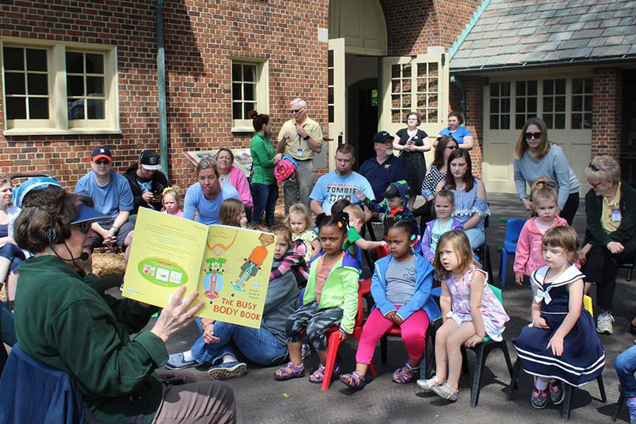 Group of kids listen in to a storyteller