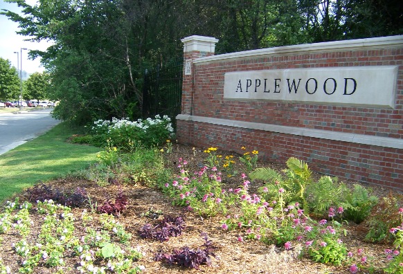 The brick Applewood sign near the parking lot entrance