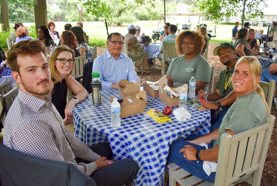 Staff and board members enjoy the covered seating area