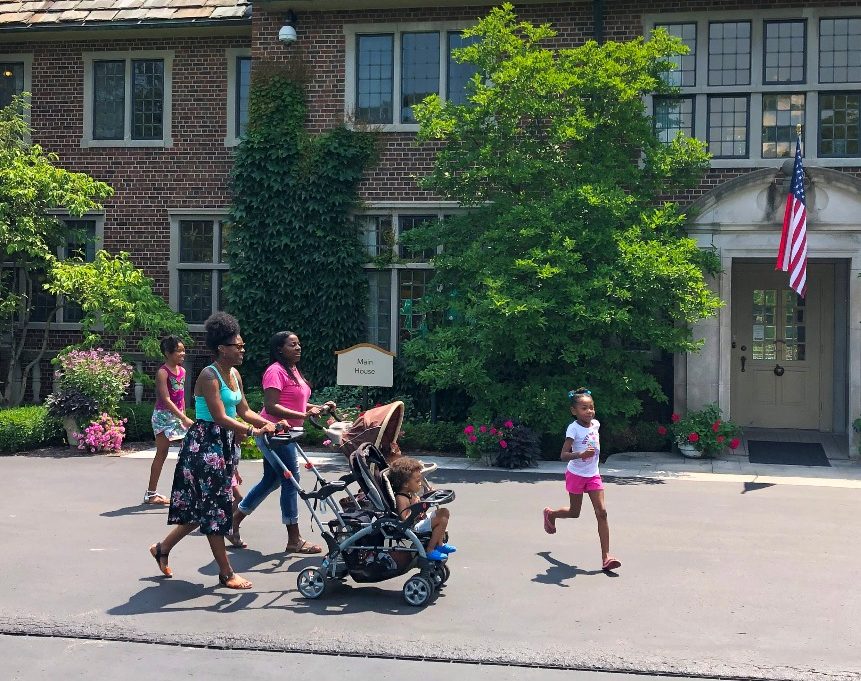 Family walks by house