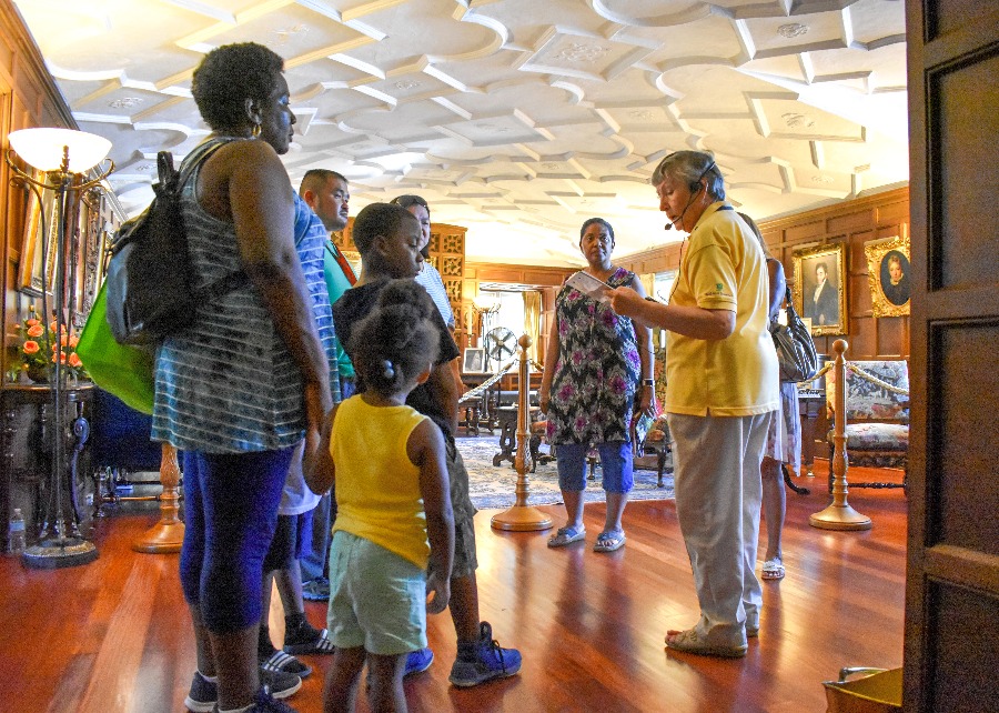 A guide leads a tour in the living room at Applewood