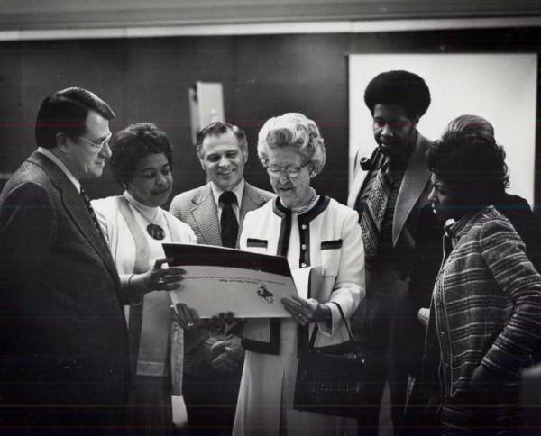 Ruth Mott looks at a document among a group of others