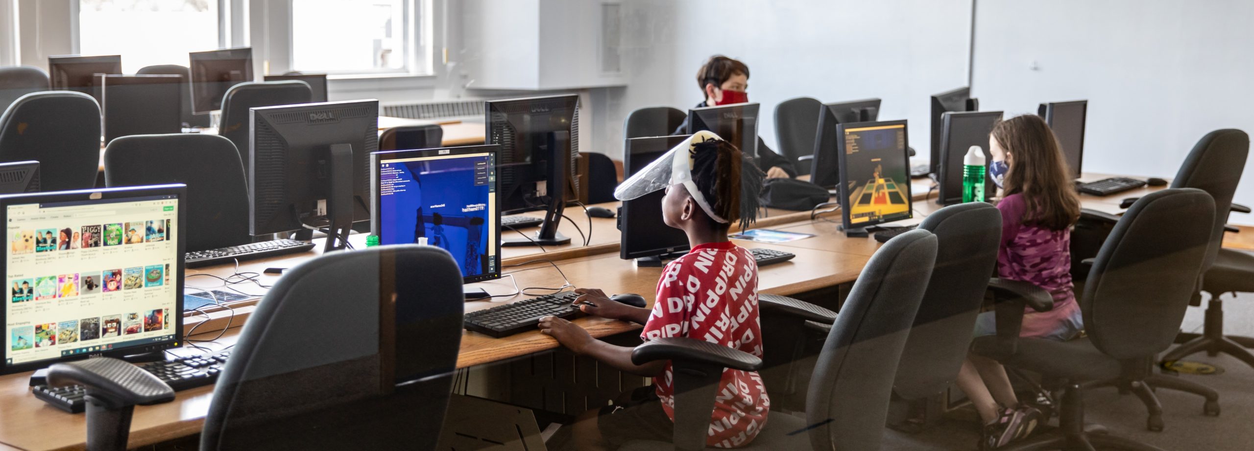 Youth use the computer lab at Sylvester Broome Empowerment Village