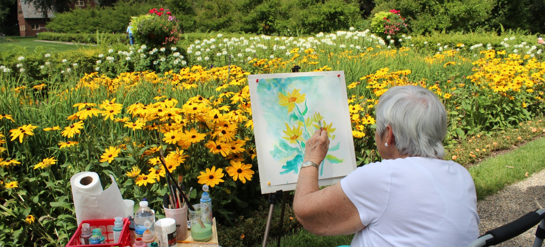 Woman painting in the gardens