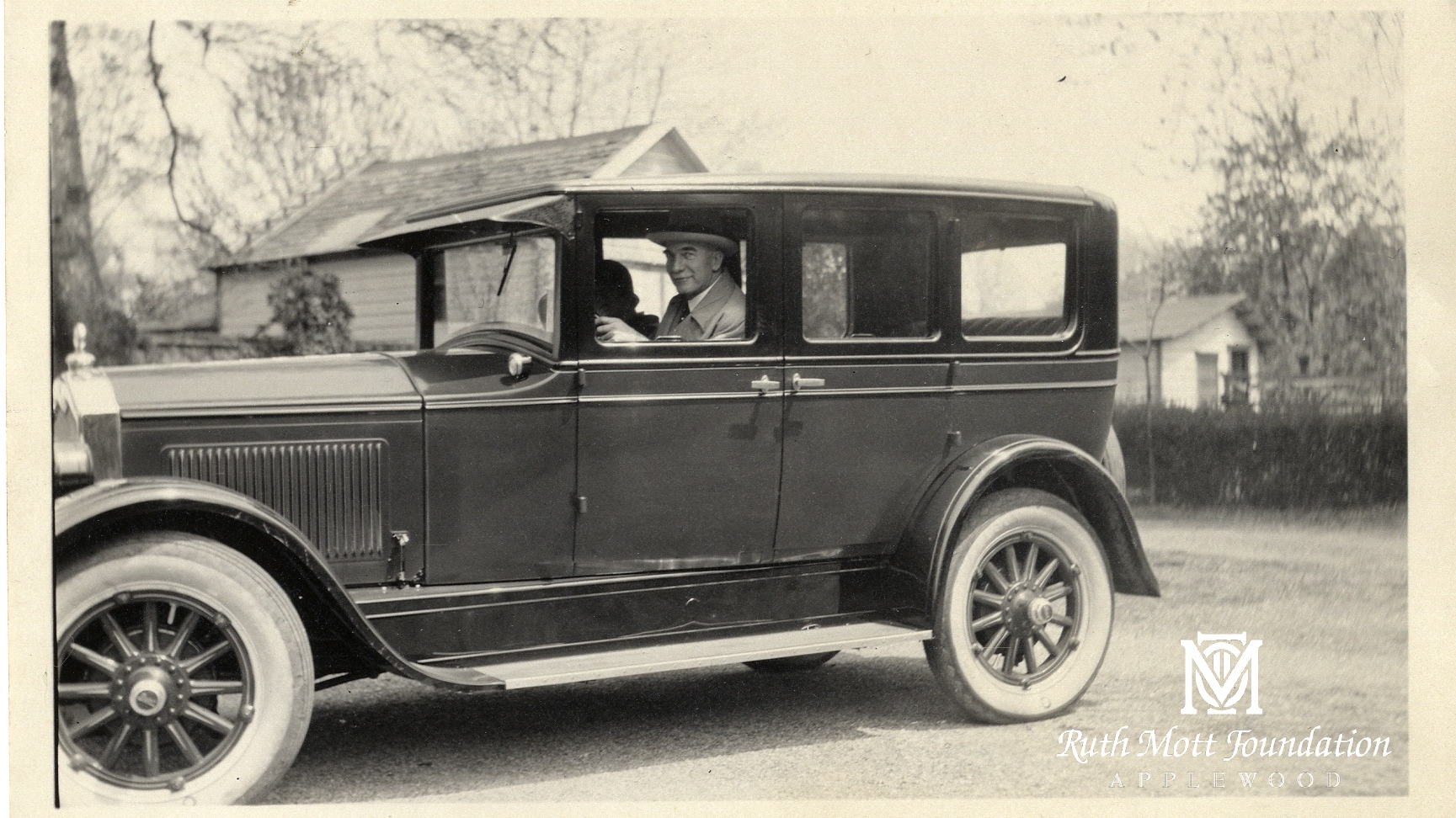 Historic photo of C.S. in a car