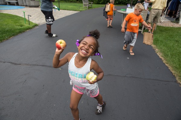 A child holds two apples