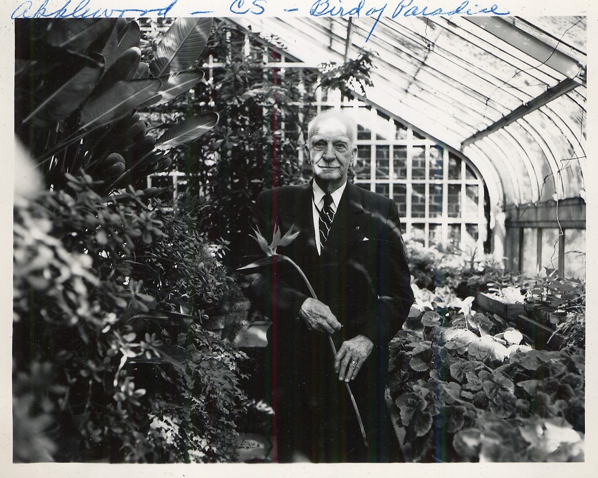 C.S. Mott holds a Bird of Paradise bloom