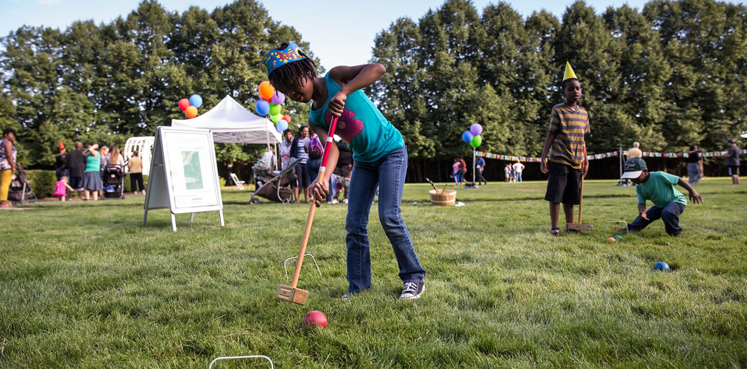 Children playing games outside at Applewood Estate 100th Anniversary.