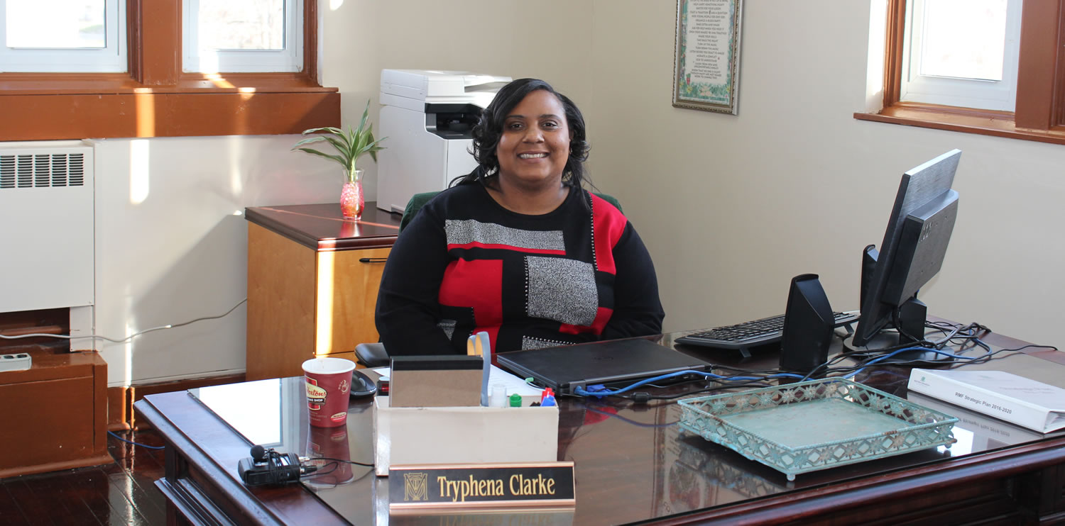 Tryphena Clarke smiling in her office at the new community engagement office in north Flint.