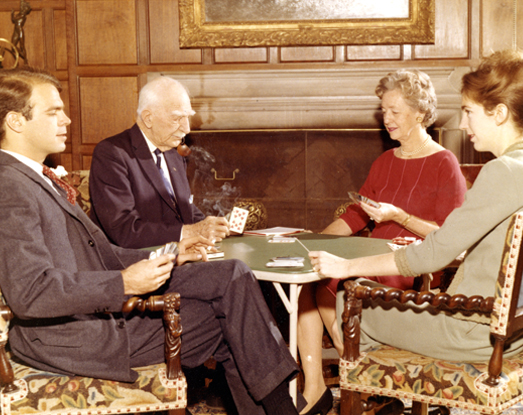 Family members playing cards in the living room