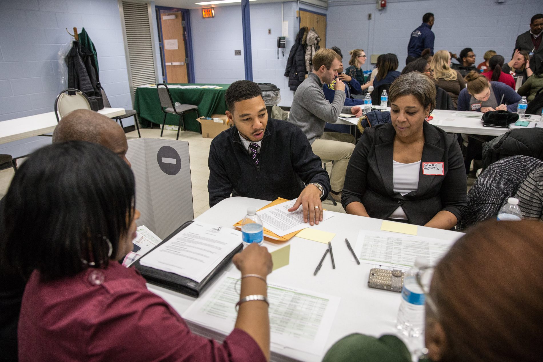 A Ruth Mott Foundation staff member talks about grantmaking with a community member at a public forum.