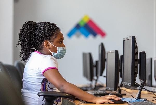 A child sits in the computer lab at Sylvester Broome Empowerment Village