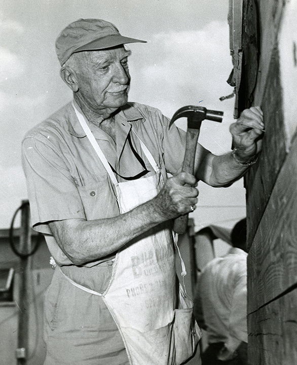 C.S. Mott hammers a nail while assisting with recovery efforts after the Beecher tornado.