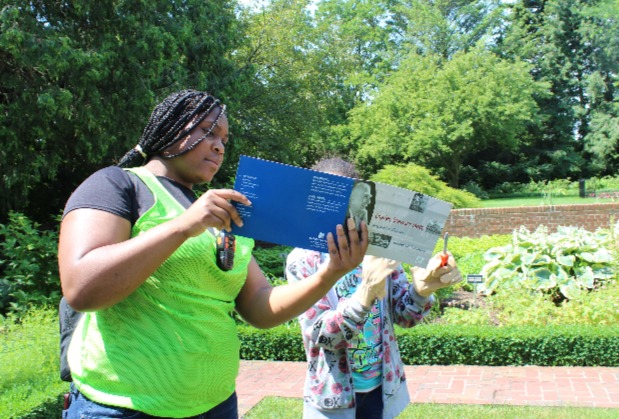 Field trip students read a book in the gardens