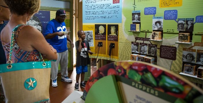 A boy listens to audio in the Applewood garage exhibit