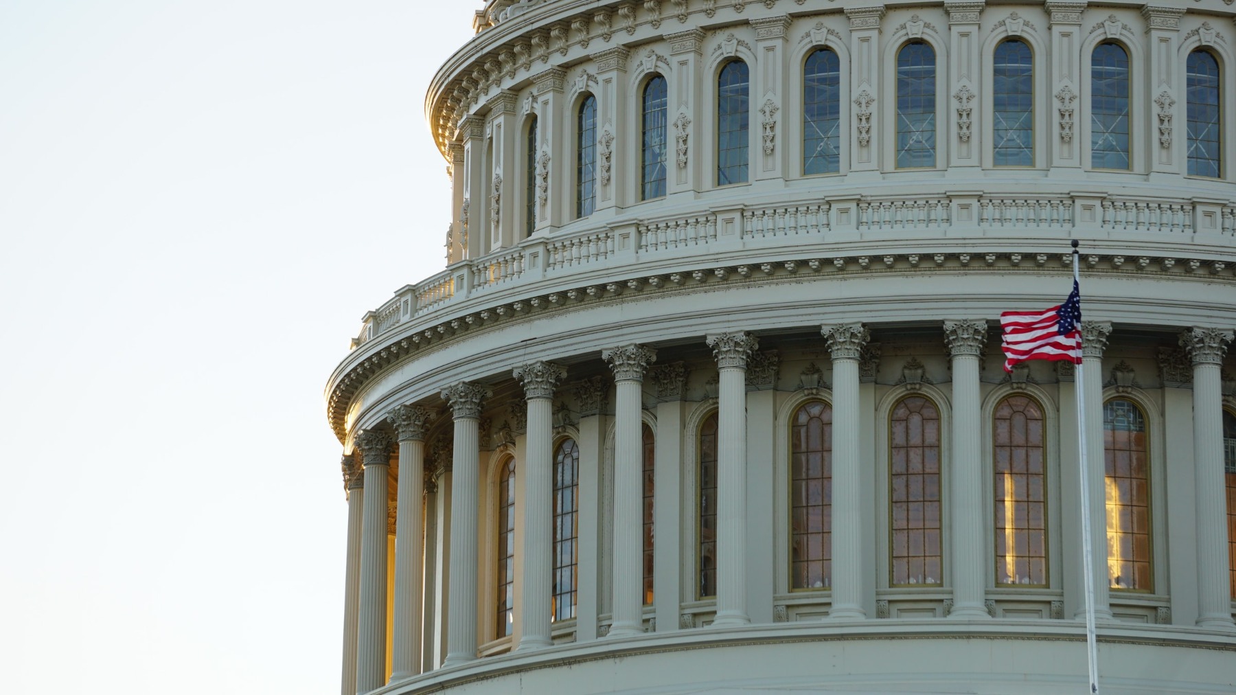 United States Capitol building in Washington, DC with an American flag flying.