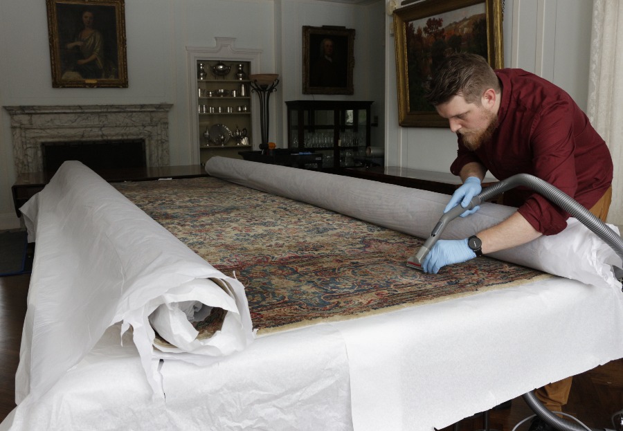 Collection technician Malcolm Cottle cleans a historic run in the dining room at Applewood.