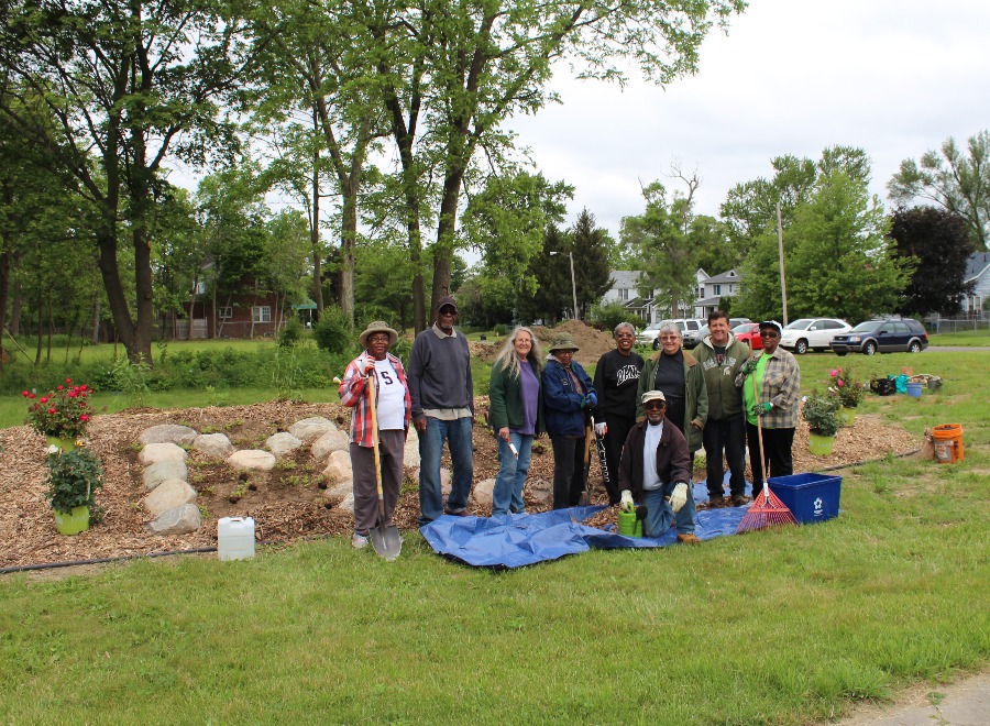 A group of RMF horticulture staff and neighborhood residents pose for a picture while working on the MLK Avenue Peace Garden in north Flint.