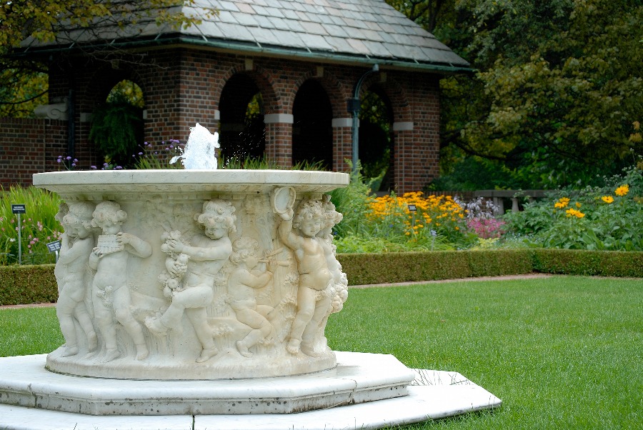 The intricately carved marble wellhead sits in the middle of the perennial garden at Applewood