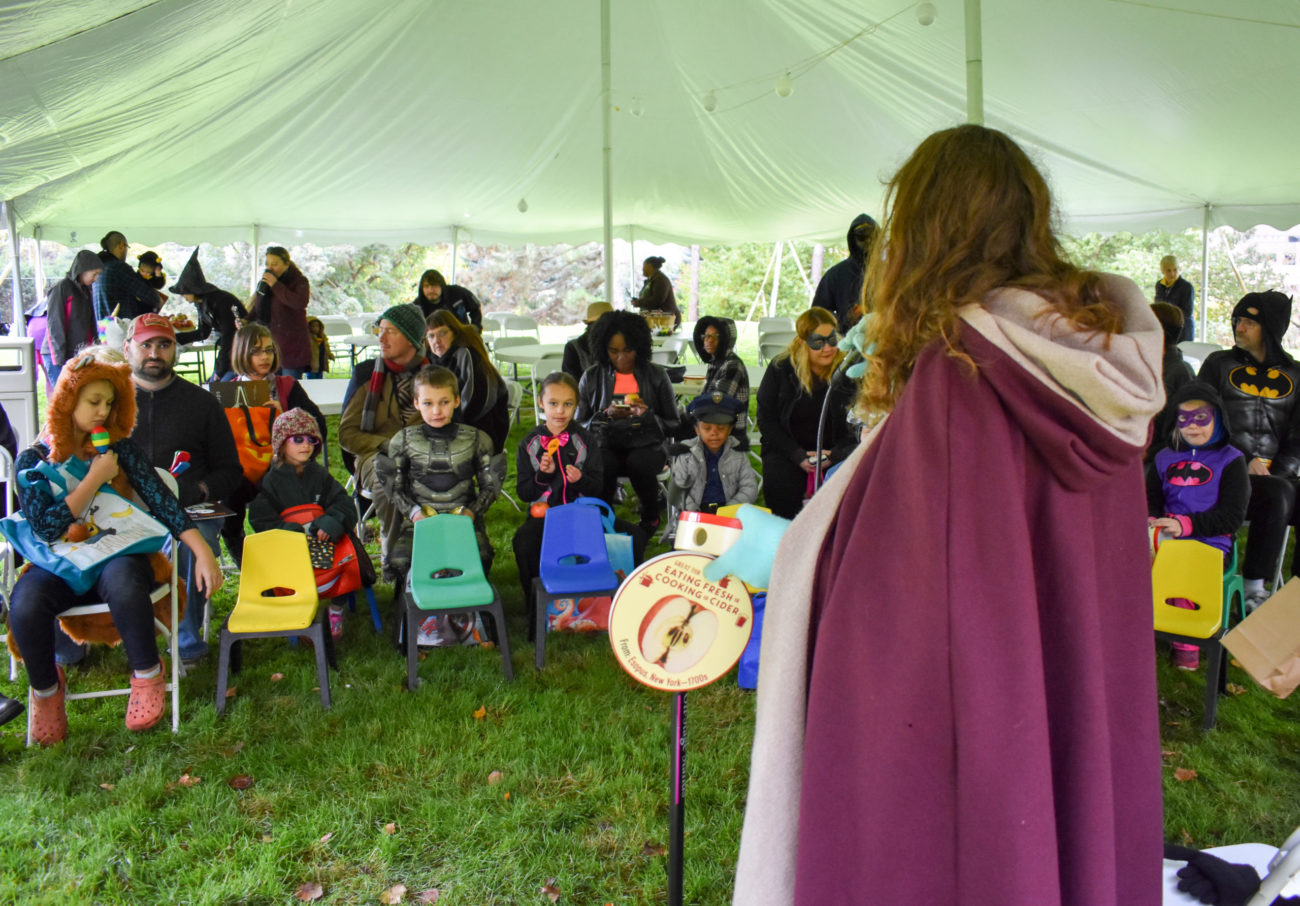 Children attend Storytime at Applewood under a tent