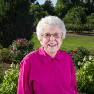 Headshot of Harriet Kenworthy wearing a deep pink shirt at Applewood