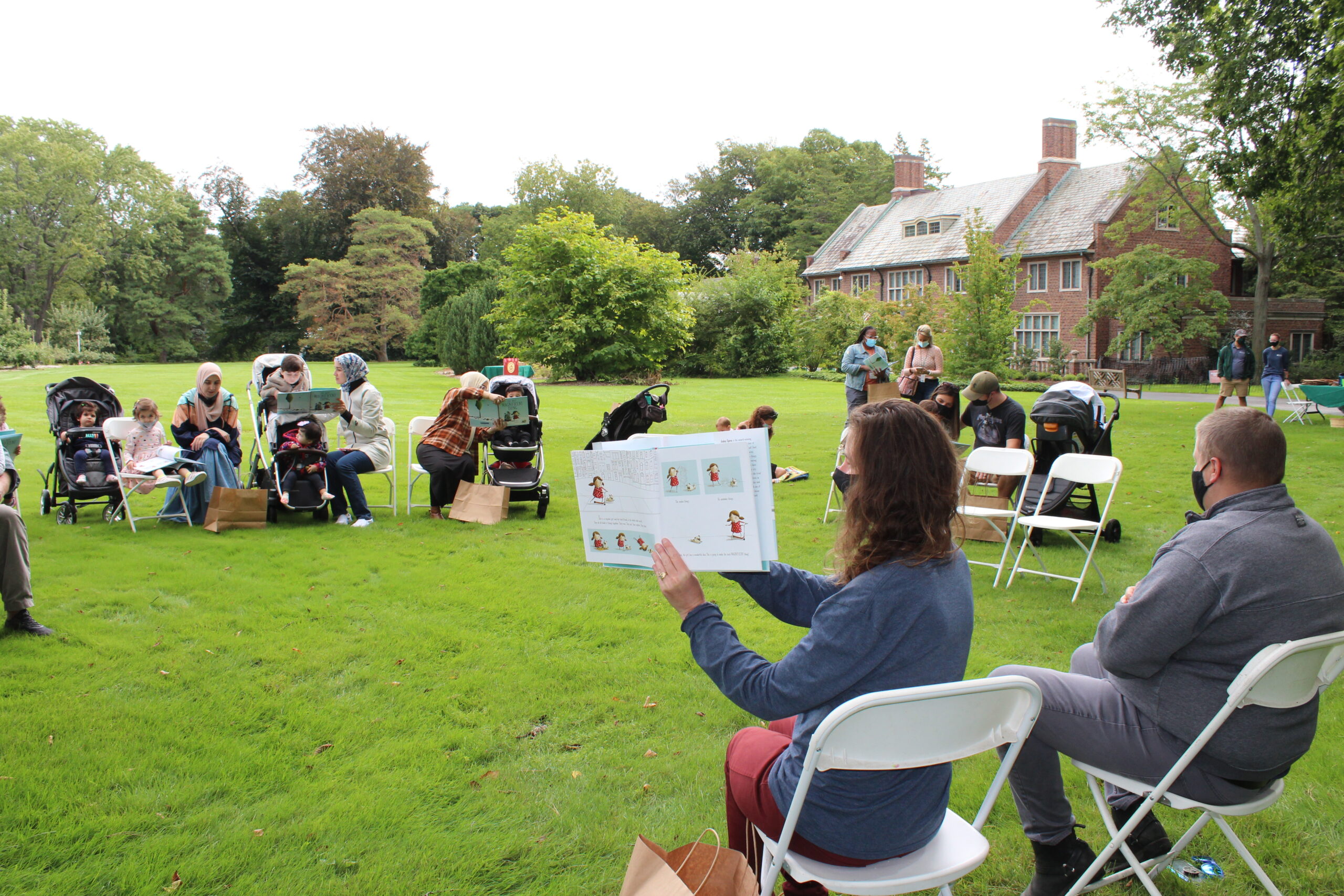 https://www.ruthmottfoundation.org/wp-content/uploads/2022/04/people-at-storytime-at-applewood-wearing-masks-scaled.jpg