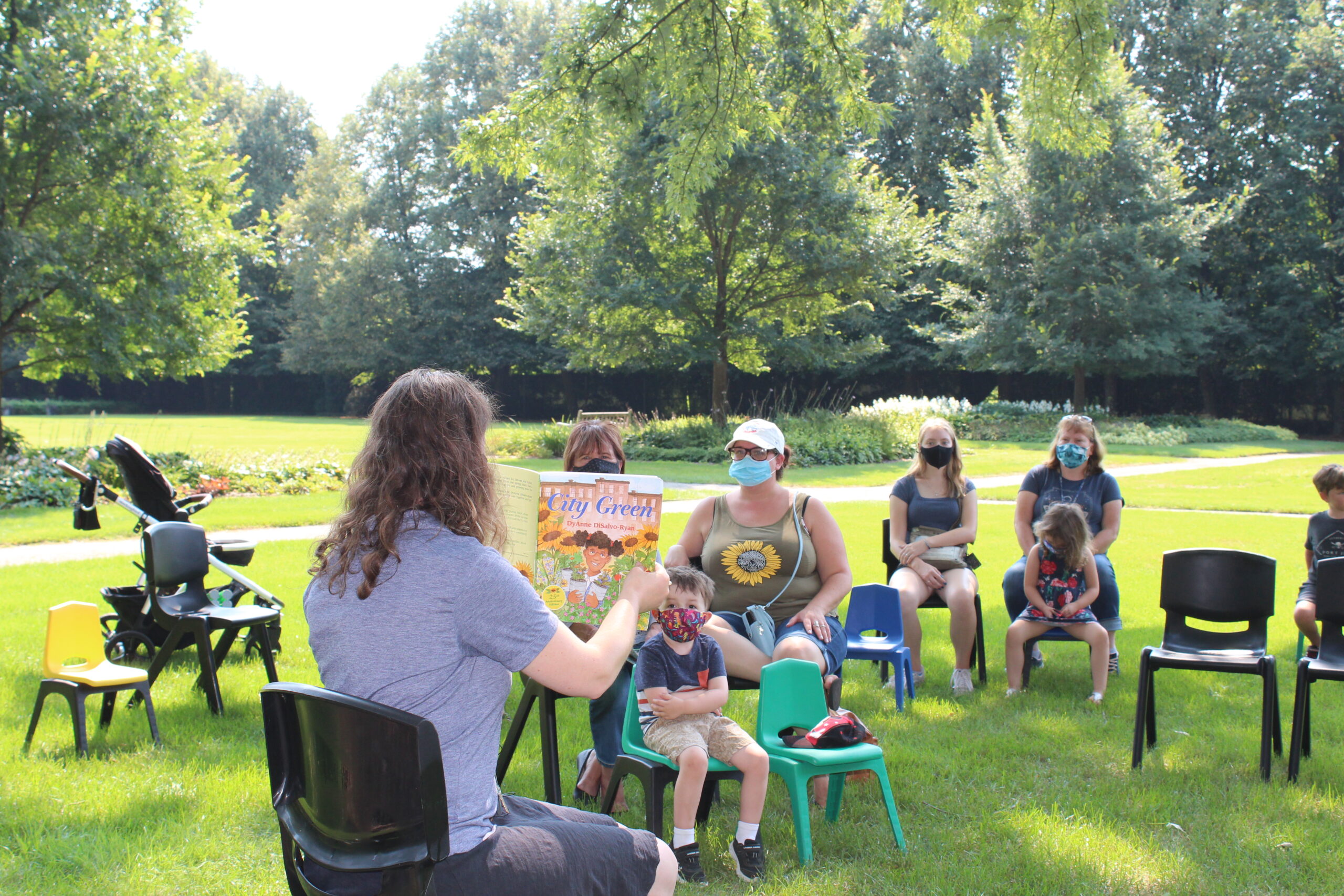 https://www.ruthmottfoundation.org/wp-content/uploads/2022/05/parents-and-children-listening-to-storytime-at-applewood-scaled.jpg