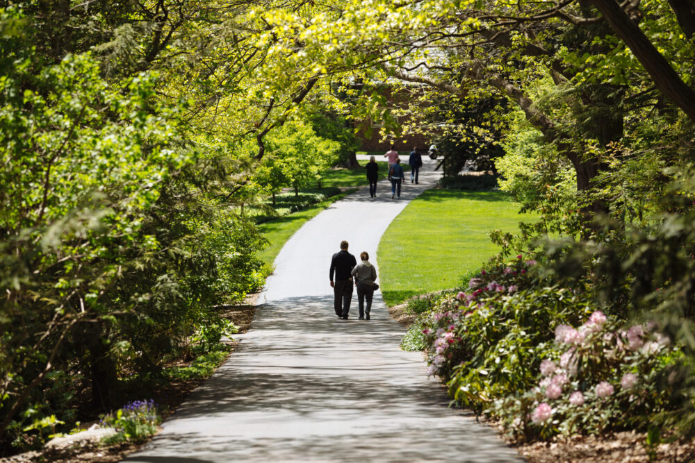 Two people strolling down a path in Applewood Park.