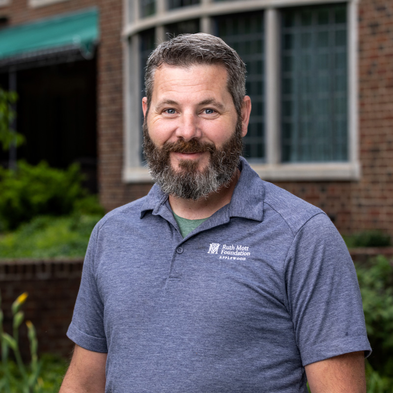 Michael Popler standing in front of a brick building.